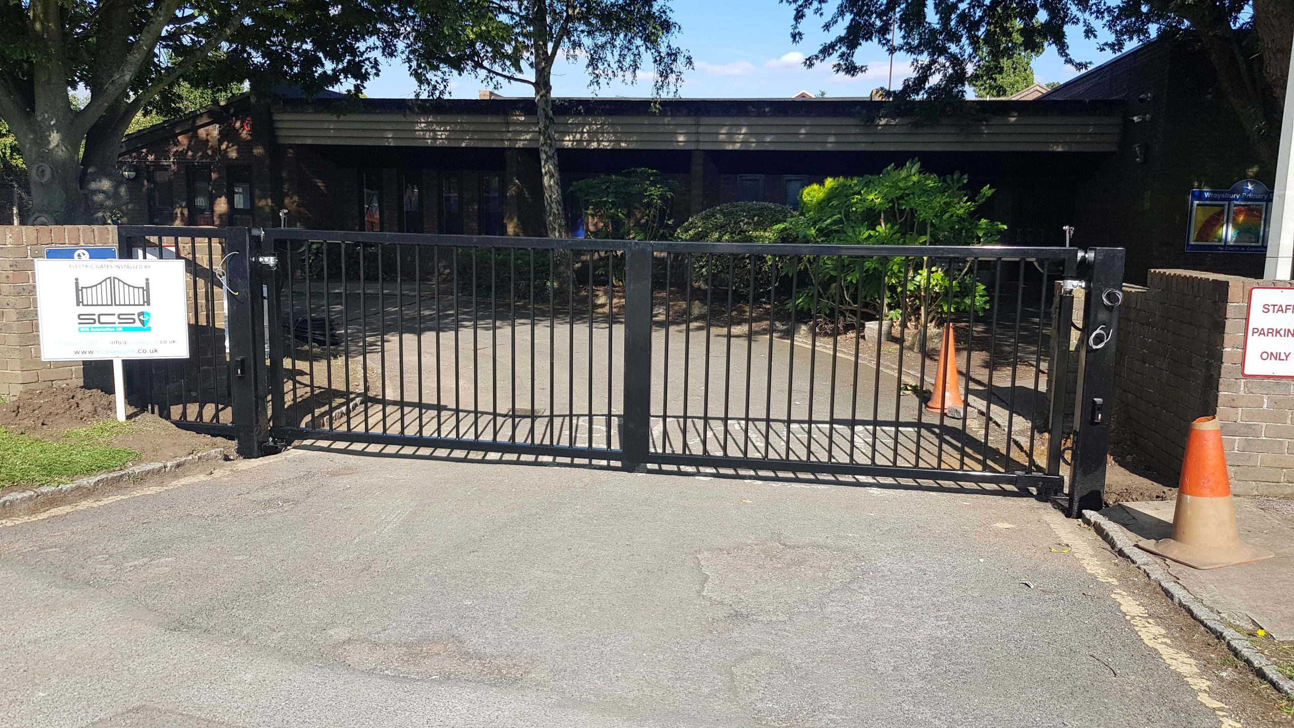 Metal sliding gate with SCS sign